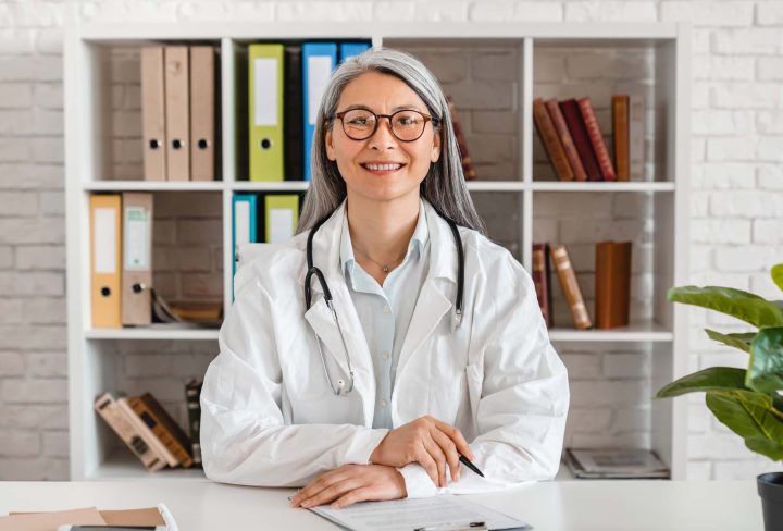 happy-middle-aged-woman-doctor-sitting-at-the-desk-2022-07-06-23-03-01-utc.jpg