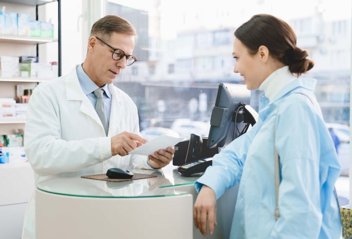 pharmacist-looking-at-medical-prescription-selling-2022-01-12-22-33-04-utc.jpg